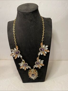 Gold tone necklace with purple brown and white stones